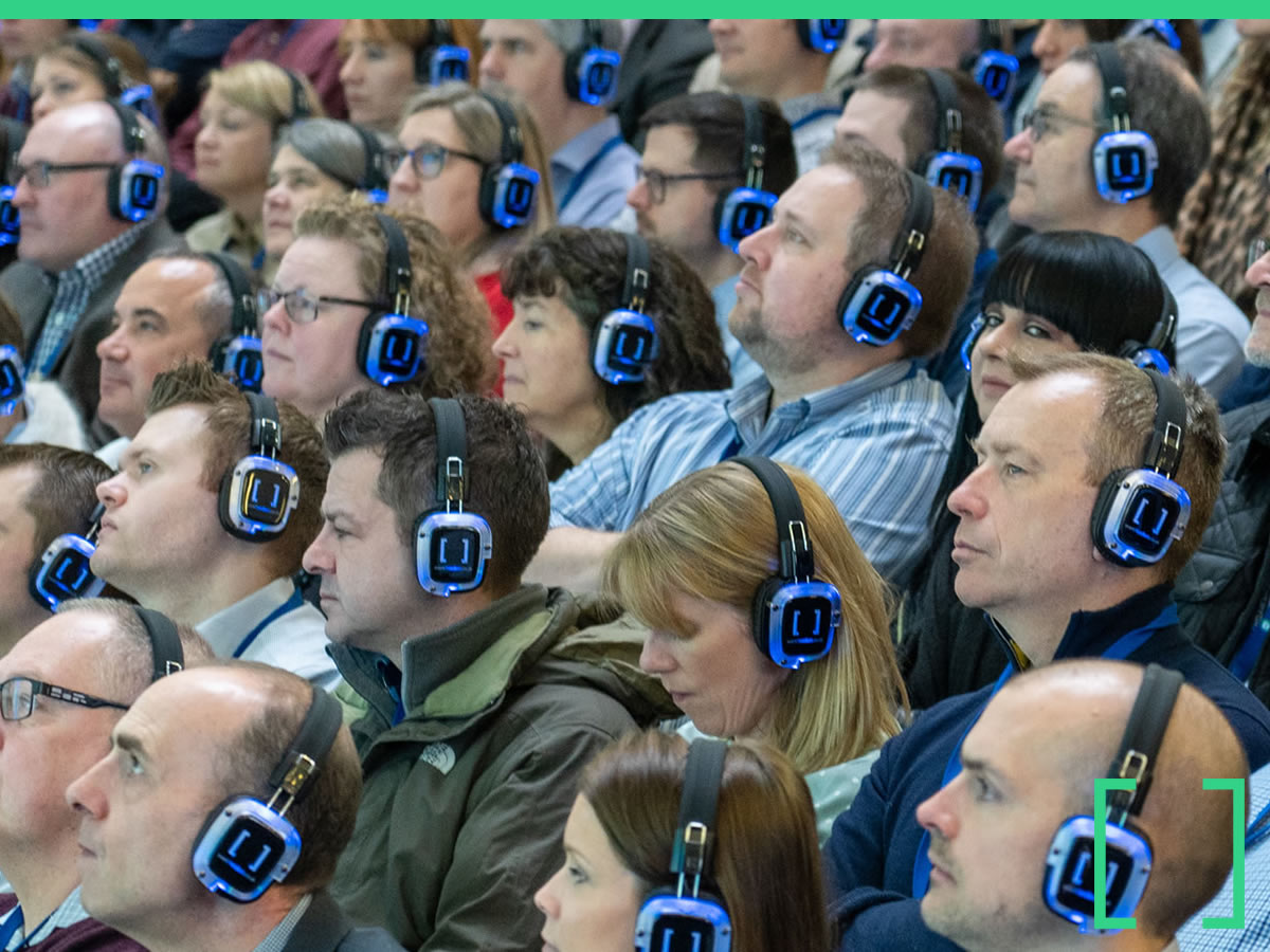 Conference delegates listening through wireless headsets